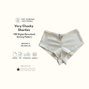 May include: Cream-coloured, ribbed fabric shorties with a delicate lace trim and a small bow. The image includes text: "Very Cheeky Shorties" and "PDF Digital Download Sewing Pattern". Sizes XS, S, M, L, XL are listed.