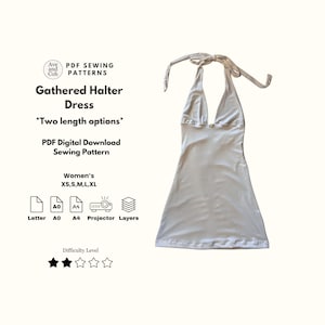 May include: A white gathered halter dress with a plunging neckline and tie straps. The dress is a PDF digital download sewing pattern, with options for two lengths. The pattern includes sizes XS, S, M, L, and XL.