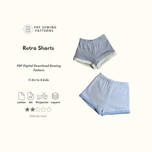 May include: Image of two pairs of retro shorts in gray and white, with contrasting trim. The text "Retro Shorts" and "PDF Digital Download Sewing Pattern" are displayed. The pattern is for sizes 0-3 months to 6 kids.