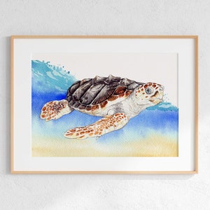 May include: Watercolor painting of a sea turtle swimming in the ocean. The turtle has a brown and black shell, with white and orange markings on its head and flippers. The artwork is framed in a light wood frame.
