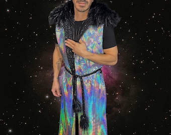 May include: A long, iridescent, sequined vest with a black fur collar and a black rope belt with tassels. The vest reflects a rainbow of colors. The person in the image is wearing sunglasses and a black t-shirt.