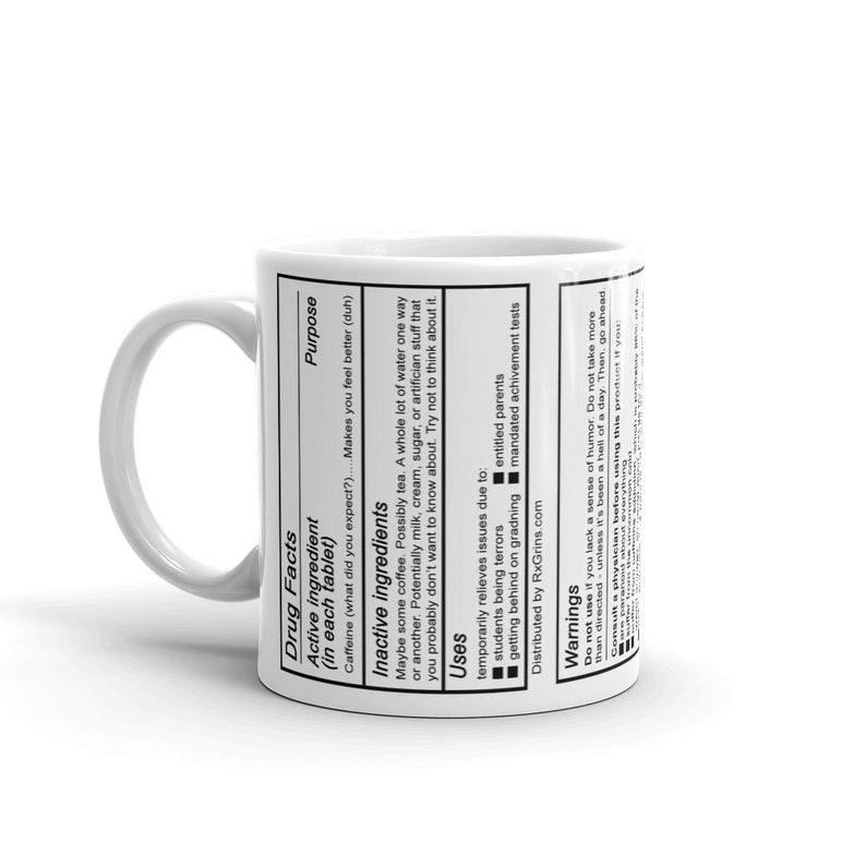 May include: White ceramic coffee mug with black text that reads "Drug Facts" and lists ingredients and uses. The text includes "Active ingredient (in each tablet) Caffeine (what did you expect?) Makes you feel better (duh)"