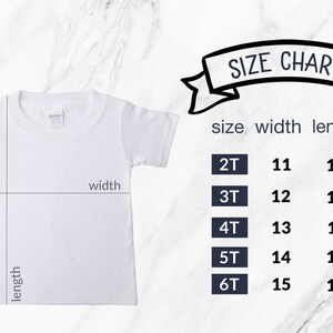 May include: White toddler t-shirt with size chart. The chart shows measurements for sizes 2T to 6T, with width and length in inches. The text "SIZE CHART" is displayed in a banner above the size information.