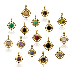 May include: A selection of gold-coloured pendants featuring diverse gemstones. Each pendant has a square frame with a circular gemstone at its centre. The gemstones are in shades of green, red, black, purple, and blue.