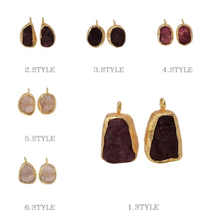 May include: A collection of gemstone pendants in various styles. Each pendant features a raw-cut gemstone with a gold-colored metal border and a loop for hanging. The gemstones are in shades of pink, purple, and beige. The text "STYLE" is visible.