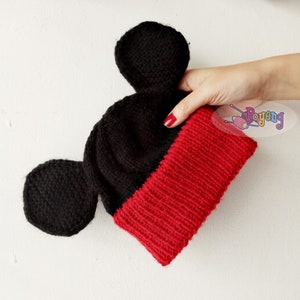 May include: Black and red knitted hat with Mickey Mouse ears.