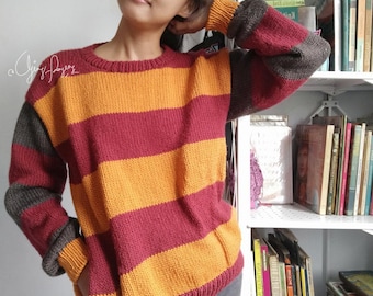 May include: A long-sleeved knit sweater featuring wide horizontal stripes in deep red and golden yellow. The sweater has a round neckline, ribbed cuffs, and a ribbed hem. The sleeves are accented with dark gray sections at the shoulders and cuffs.