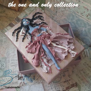 The CORPSE BRIDE in love handmade in polymer clay on a cardboard box