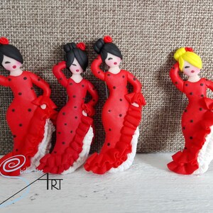 May include: Four handmade red and black polka dot flamenco dancer figurines. Each figurine has a white ruffled skirt and black hair. One figurine has yellow hair.