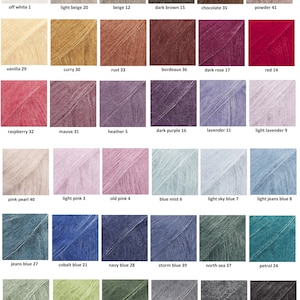 May include: A color chart displaying a variety of yarn shades. The chart includes colors such as off-white, light beige, dark brown, red, and various shades of blue and green. Each color is labeled with a name and number.