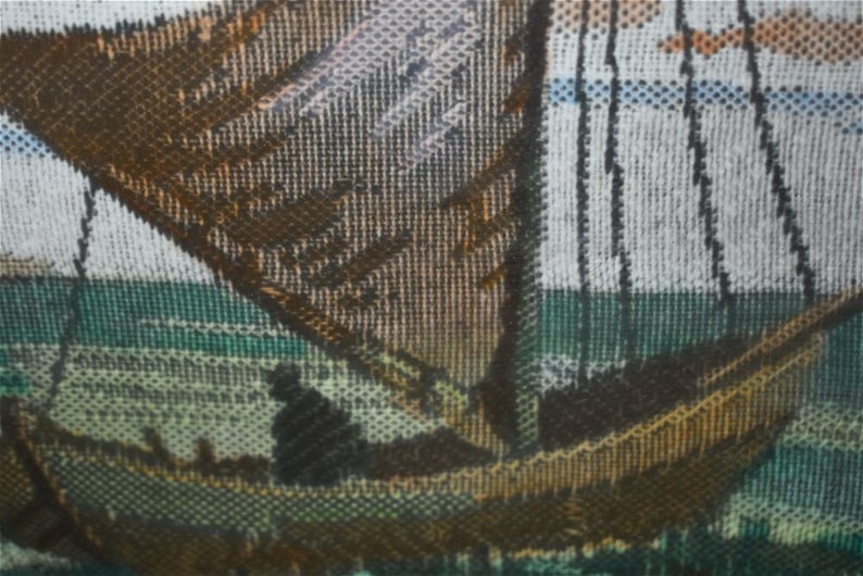 May include: A detailed image of a sailboat on the water. The boat is brown with a large sail, and there is a person in the boat. The water is green and the sky is light blue with some orange.