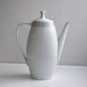 May include: White ceramic teapot with a gray stripe design. The teapot has a rounded body and a spout on the side.