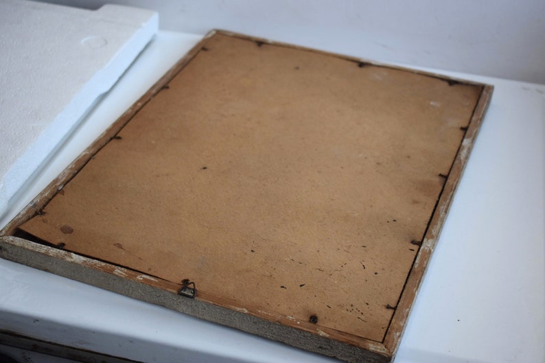 May include: A plain, brown picture frame with a white painted wooden frame. The frame is slightly distressed and has a few small nail holes.
