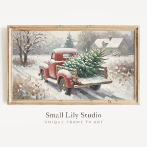 May include: A framed print depicting a red vintage pickup truck transporting a Christmas tree through a snowy scene. The artwork has a winter theme, with a house and trees in the background. The text "Small Lily Studio" is at the bottom.