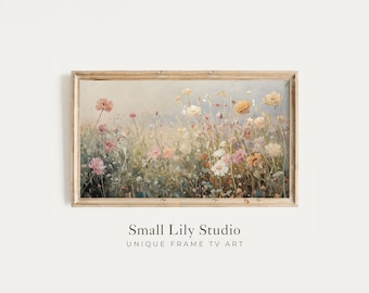 May include: A rectangular framed wall art piece featuring an impressionistic painting of a wildflower meadow with soft pink, yellow, and white blossoms against a muted green and beige background. The text Small Lily Studio UNIQUE FRAME TV ART is below.