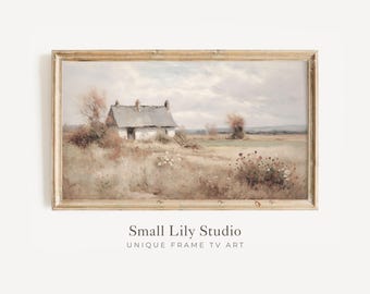 May include: A framed landscape painting depicts a quaint cottage with a gray roof nestled in a field of tall, dry grass. The artwork features muted tones of beige, brown, and gray, with a cloudy sky overhead. The frame is a light, natural wood color.