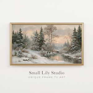 Op de afbeelding: Een rechthoekig landschapsschilderij in een gouden lijst met een besneeuwd winterbos, groenblijvende bomen, kale berken en een rustige rivier onder een zachte zonsonderganghemel. De tekst Small Lily Studio UNIQUE FRAME TV ART staat eronder.