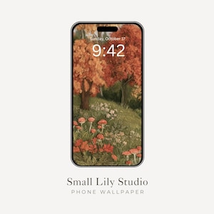 Könnte beinhalten: Ein Smartphone mit einem digitalen Hintergrundbild einer herbstlichen Waldszene mit orangefarbenen und roten Bäumen, grünem Gras und roten Pilzen. Das Display zeigt die Uhrzeit 9:42 und das Datum Sonntag, 17. Oktober. Unter dem Telefon steht Small Lily Studio.