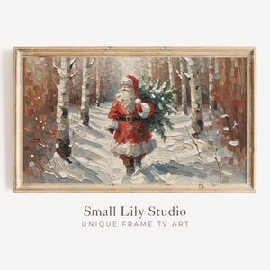 Puede incluir: Pintura enmarcada de Papá Noel caminando por un bosque nevado, llevando un árbol de Navidad. La obra de arte utiliza rojos, blancos y marrones, con abedules bordeando el camino. El texto "Small Lily Studio" está en la parte inferior, con "UNIQUE FRAME TV ART".