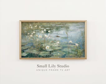 May include: A rectangular landscape painting in a thin gold frame depicting a pond with white water lilies and green lily pads. The artwork features soft brushstrokes in shades of blue, green, and white. Below the frame is the text Small Lily Studio.