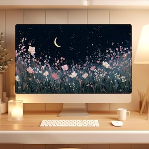 May include: A desktop computer displays a digital art scene of a night sky with a crescent moon and a field of flowers in pink, white, and green. The computer sits on a wooden desk with a keyboard, mouse, and a white mug.