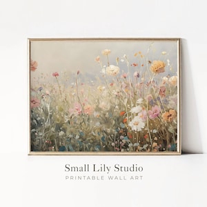 Op de afbeelding: Een ingelijste print van een bloemenweide in pastelkleuren. Het kunstwerk toont een verscheidenheid aan bloemen in roze, geel en wit, tegen een zachte achtergrond. De tekst "Small Lily Studio Printable Wall Art" staat onderaan de afbeelding.