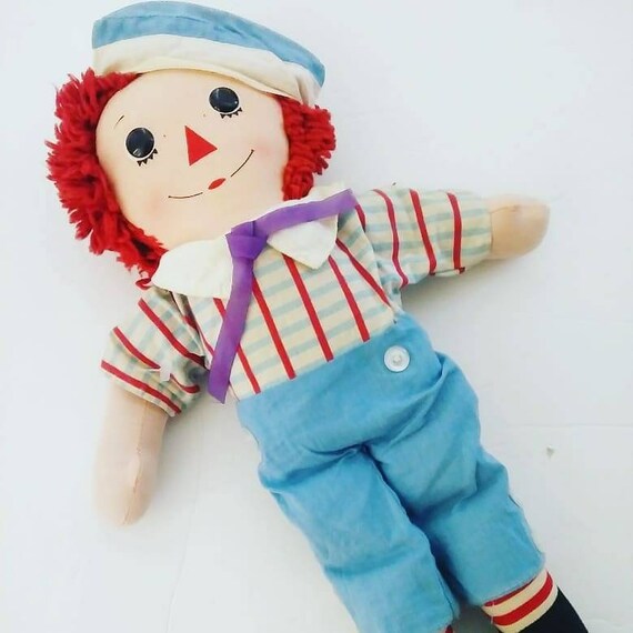 red haired doll with a triangle nose