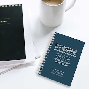 May include: A blue spiral bound journal with the text "STRONG 40 DAYS OF PUTTING JESUS AT THE CENTER CLEERELY Stated cleerelystated.com" on the cover.