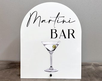 Könnte beinhalten: Weißes Schild mit schwarzem Text, der "Martini Bar" lautet, und einer Zeichnung eines Martini-Glases mit einer Olive.