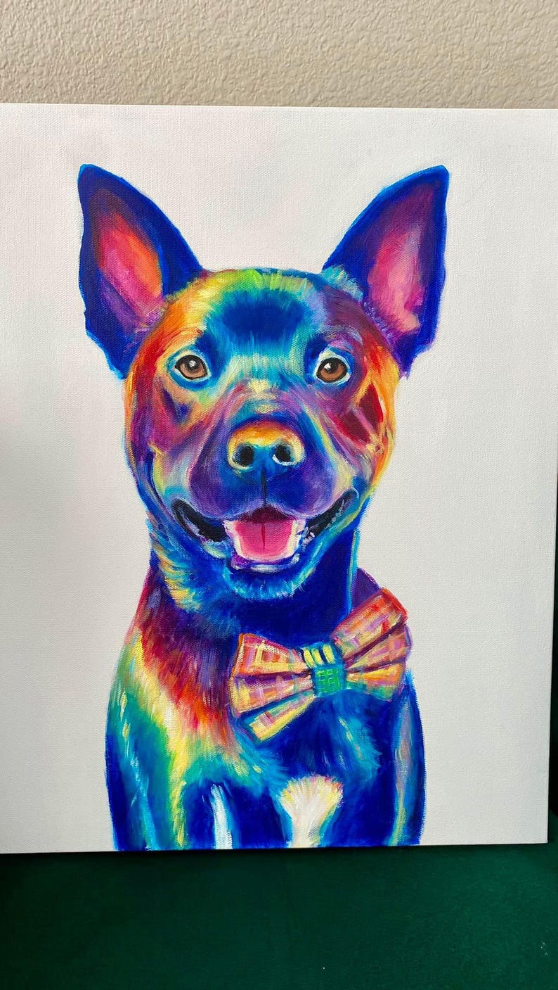 May include: A colorful painting of a dog wearing a bow tie. The dog is painted in shades of blue, purple, green, yellow, and orange. The bow tie is yellow, green, and orange.