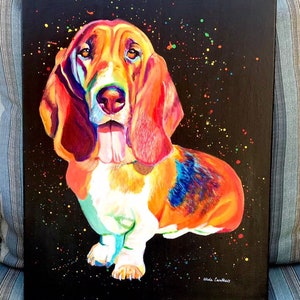 May include: A colorful painting of a basset hound dog with a black background and colorful splatter paint. The dog is painted in shades of orange, red, yellow, blue, and white. The artist's signature is in the bottom right corner.