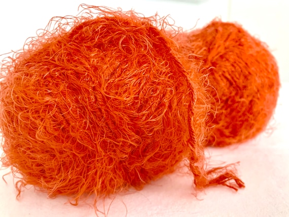 92 yards of Soft and fuzzy comforting wool-containing orange yarn with sparkle.