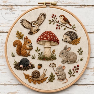May include: An embroidery hoop containing a fabric panel with a PDF pattern featuring a central red and white mushroom surrounded by a brown owl, a squirrel, a mole, a snail, a hedgehog, a rabbit, a mouse, and various botanical elements.