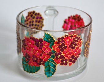May include: A clear glass mug featuring hand-painted hydrangea flower clusters in shades of vibrant pink, deep purple, and magenta, accented with bright teal green leaves and outlined in gold metallic paint, showcasing a transparent cylindrical body.