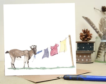May include: A watercolour illustration of a goat chewing on a blue ribbon hanging from a washing line. There are three other items of clothing hanging on the line: a red shirt, a blue shirt, and a yellow shirt.