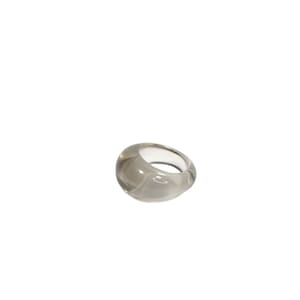 May include: A clear, translucent ring made of resin. The ring has a rounded, organic shape.