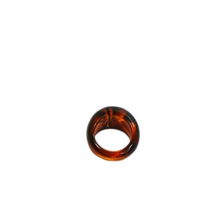 May include: A brown tortoiseshell ring with a smooth, rounded surface.