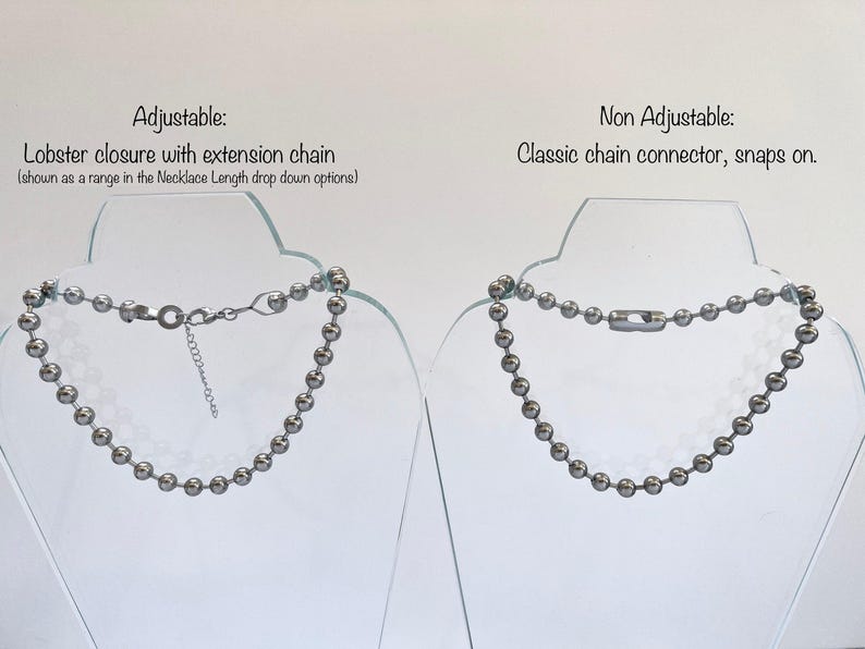 May include: Two silver ball chain necklaces on display stands. The necklace on the left has a lobster clasp with an extension chain. The necklace on the right has a classic chain connector that snaps on.