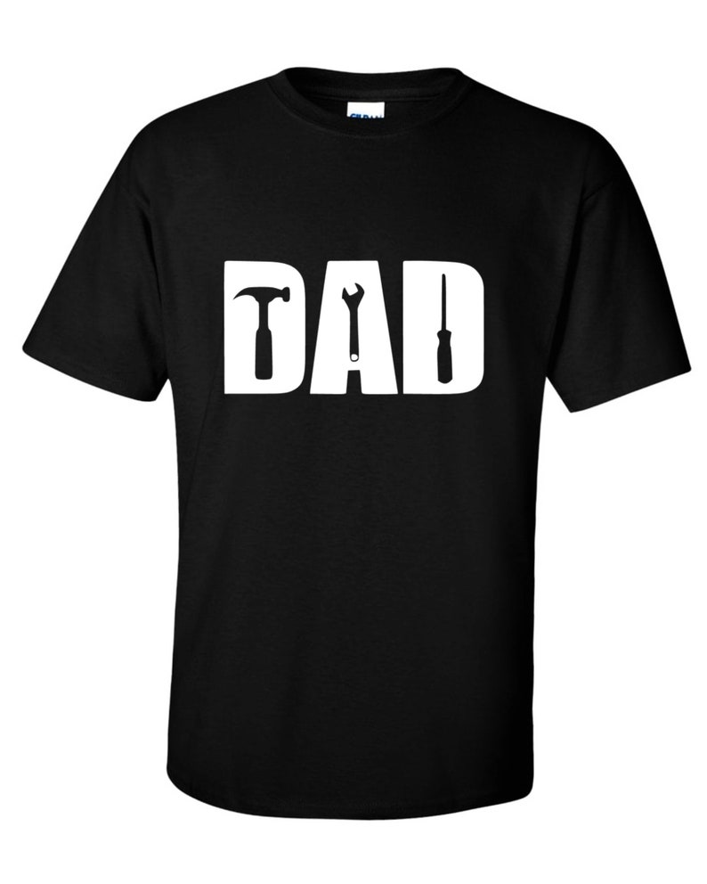 May include: Black t-shirt with a white graphic of the word "DAD" with a hammer, wrench, and screwdriver replacing the letters.