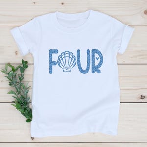 May include: White t-shirt with blue glitter text that says "FOUR" with a seashell in the "O".