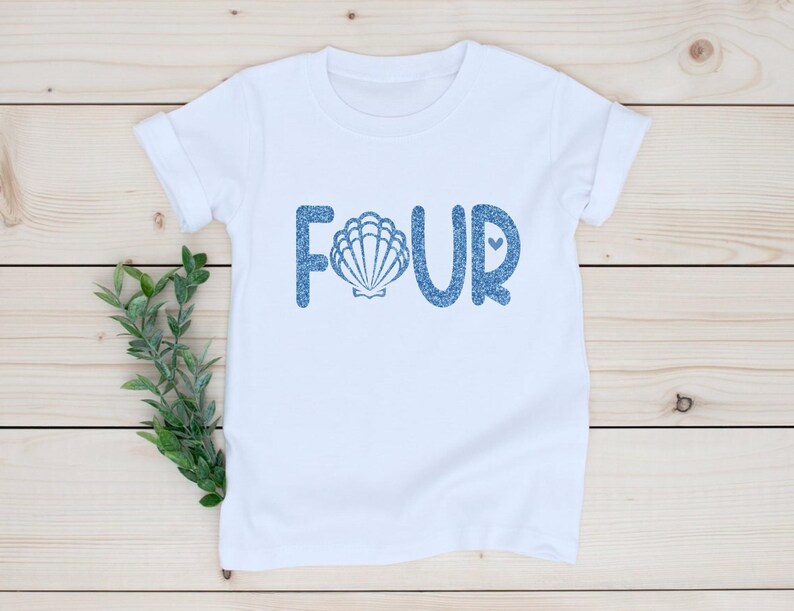 May include: White t-shirt with blue glitter text that says "FOUR" with a seashell in the "O".
