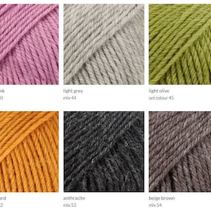 May include: Six skeins of yarn in different colors: light old pink, light grey, light olive, dark mustard, anthracite, and beige brown. The yarn is arranged in two rows of three skeins each.