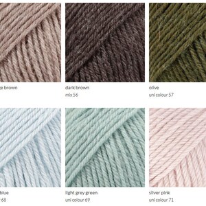 May include: Yarn balls in various colors, including light beige brown, dark brown, olive, light sky blue, light grey green, and silver pink. The yarn is arranged in a grid pattern.