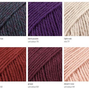May include: Yarn samples in various colors, including petrol cerise, dark purple, light oak, maroon, grape, and desert rose. The yarn is arranged in a grid pattern.