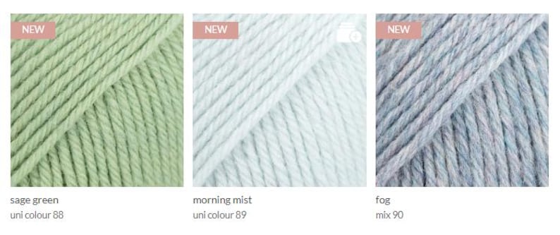 May include: Three skeins of yarn in different colors: sage green, morning mist, and fog. The yarn is labeled with the color name and a number.