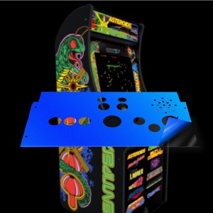 May include: A blue control panel with multiple round holes for buttons and a single hole for a joystick. The panel is being peeled back to reveal a black surface underneath.