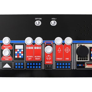 May include: A black control panel with white buttons and a black knob. The panel has labels for "One Player Start", "Two Player Start", "Rotate Left", "Rotate Right", "Thrust", "Fire", and "Shields".