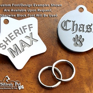 K&ouml;nnte beinhalten: Zwei silberne Hundemarken mit gravierten Namen. Eine Marke ist sternf&ouml;rmig mit dem Text "SHERIFF MAX" und die andere ist rund mit dem Text "Chase" und einem Pfotenabdruck mit einem Herz in der Mitte.