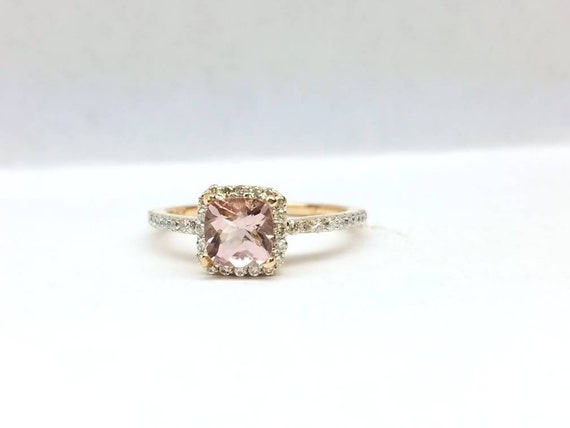 Morganite engagement ring with halo set in 14k rose gold.