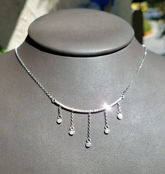 Dainty Gold bar necklace with dangling diamonds.